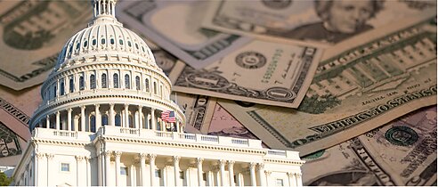 The Capitol building with U.S. paper currency in the background