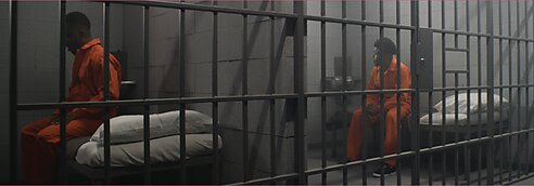 Prison inmates sit in their cells