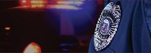 Police badge against police car lights background