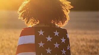 Young girl wrapped in an American flag