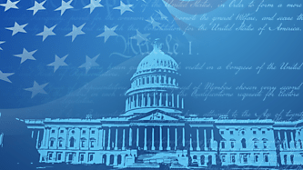 Capitol building against a blue American flag